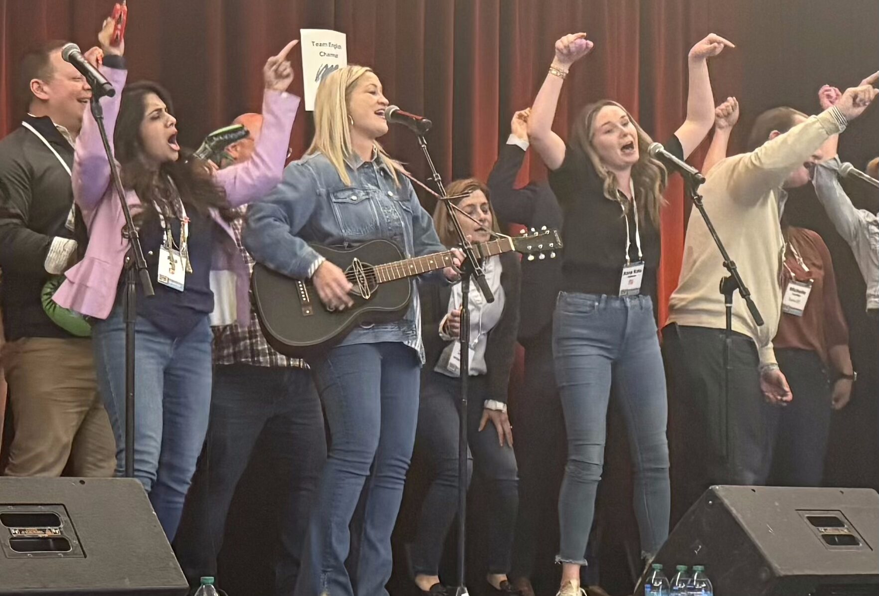 people performing a song at a team building program