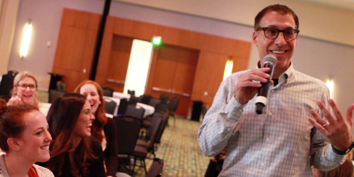 A professional keynote speaker engaging an audience