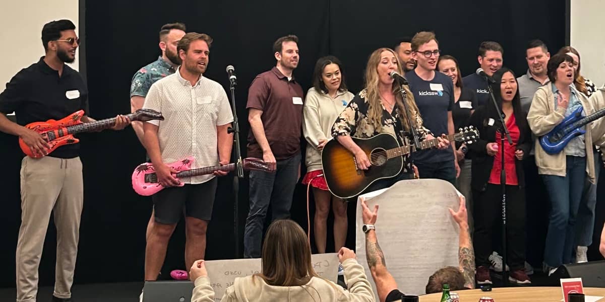a group performing a song at a team building event