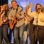 a team building group performing the song they wrote